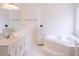 A bright bathroom with a soaking tub at 3533 Saddlebrook Dr, Loganville, GA 30052