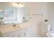 Bright bathroom with a white corner tub, window, and vanity at 3533 Saddlebrook Dr, Loganville, GA 30052