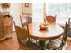 Cozy dining area with a round wood table and fruit centerpiece at 3533 Saddlebrook Dr, Loganville, GA 30052