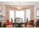 Formal dining room with chandelier, traditional wallpaper, and ample natural light at 3533 Saddlebrook Dr, Loganville, GA 30052