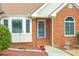 Inviting front entrance with brick facade, decorative window, and seasonal wreath on the door at 3533 Saddlebrook Dr, Loganville, GA 30052