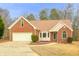 Charming brick home with a manicured lawn, attached garage, and inviting front entrance at 3533 Saddlebrook Dr, Loganville, GA 30052