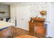 An eat-in kitchen shows floral wallpaper and wood floors at 3533 Saddlebrook Dr, Loganville, GA 30052