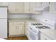 Bright kitchen with white cabinets and countertops, and matching appliances at 3533 Saddlebrook Dr, Loganville, GA 30052