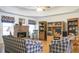 Bright living room with hardwood floors, brick fireplace, tray ceiling, and built-in shelving at 3533 Saddlebrook Dr, Loganville, GA 30052