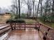 A wooden back deck with a wooden surround overlooks a lush yard and a privacy fence at 4617 N Peachtree Rd, Dunwoody, GA 30338