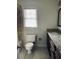 Bathroom featuring a granite counter, tiled shower, and window at 4617 N Peachtree Rd, Dunwoody, GA 30338