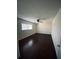A spacious bedroom with wood floors, ceiling fan and bright window at 4617 N Peachtree Rd, Dunwoody, GA 30338