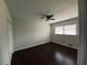 A well-lit bedroom with dark wood floors and a ceiling fan at 4617 N Peachtree Rd, Dunwoody, GA 30338