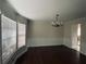 Bright dining room with hardwood floors, chandelier, and natural light from a large bay window with stylish molding at 4617 N Peachtree Rd, Dunwoody, GA 30338
