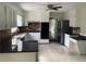 Updated kitchen with stainless steel appliances, granite countertops, and white cabinetry, with tiled floors at 4617 N Peachtree Rd, Dunwoody, GA 30338