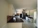 Spacious kitchen with tiled floors, stainless steel appliances, and granite countertops with eat-in breakfast nook in the background at 4617 N Peachtree Rd, Dunwoody, GA 30338