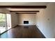 Bright living room with hardwood floors, white brick fireplace and sliding glass door at 4617 N Peachtree Rd, Dunwoody, GA 30338