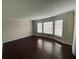 Spacious living room with hardwood floors and a bay window that provides an abundance of natural light at 4617 N Peachtree Rd, Dunwoody, GA 30338