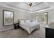 Comfortable bedroom with tray ceiling, large windows, and neutral carpet at 1007 Crown River Pkwy, Mcdonough, GA 30252