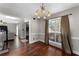Traditional dining room with hardwood floors, chandelier, and large window with natural light at 1007 Crown River Pkwy, Mcdonough, GA 30252