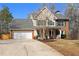 Beautiful two-story home featuring a well-manicured lawn and a classic brick facade at 1007 Crown River Pkwy, Mcdonough, GA 30252