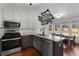 Bright kitchen featuring modern appliances, granite countertops, and an adjacent dining area at 1007 Crown River Pkwy, Mcdonough, GA 30252