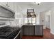 Modern kitchen with granite counters, stainless steel appliances, and a stylish pot rack at 1007 Crown River Pkwy, Mcdonough, GA 30252