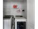 Bright laundry area with washer, dryer, and organized shelving for optimal storage solutions at 1007 Crown River Pkwy, Mcdonough, GA 30252