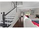 Inviting living room featuring hardwood floors, neutral color palette, and staircase at 1007 Crown River Pkwy, Mcdonough, GA 30252