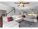 Open living room with hardwood floors, staircase, and a large sectional sofa for relaxation at 1007 Crown River Pkwy, Mcdonough, GA 30252