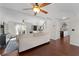 Spacious living room with hardwood floors, ceiling fans, and view of the kitchen and staircase at 1007 Crown River Pkwy, Mcdonough, GA 30252