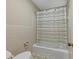 Neutral bathroom features a shower and tub combination with a striped curtain at 2153 Starfire Drive Ne Dr, Atlanta, GA 30345