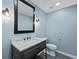 Stylish half-bathroom features a new vanity, marble countertop, modern lighting, and fresh blue paint at 2153 Starfire Drive Ne Dr, Atlanta, GA 30345