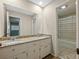 Bathroom features a double sink vanity with granite counters and decorative pulls at 2153 Starfire Drive Ne Dr, Atlanta, GA 30345
