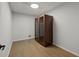 This bedroom features wood flooring and a dark wood cabinet with glass doors at 2153 Starfire Drive Ne Dr, Atlanta, GA 30345