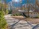 Brick single-story home with mature trees and a long driveway leading to a well-kept yard at 2153 Starfire Drive Ne Dr, Atlanta, GA 30345
