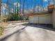 Two-car garage and a large driveway in front of a wooded area at 2153 Starfire Drive Ne Dr, Atlanta, GA 30345