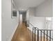 Bright hallway with hardwood floors and modern railing overlooking the front entry and stairs at 2153 Starfire Drive Ne Dr, Atlanta, GA 30345