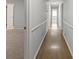 Long hallway with chair rail and wood floors leads to various rooms at 2153 Starfire Drive Ne Dr, Atlanta, GA 30345