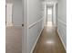 Hallway with wood floors and white walls featuring molding and access to multiple rooms at 2153 Starfire Drive Ne Dr, Atlanta, GA 30345