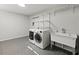 Functional laundry room with modern washer, dryer, sink, and shelving at 2153 Starfire Drive Ne Dr, Atlanta, GA 30345