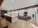 Open-concept living room featuring a kitchen island, fireplace, and hardwood floors at 2153 Starfire Drive Ne Dr, Atlanta, GA 30345