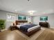 Tranquil main bedroom with wood flooring, large windows, and stylish furnishings at 2153 Starfire Drive Ne Dr, Atlanta, GA 30345