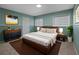 Stylish main bedroom features green walls, art and natural light at 2153 Starfire Drive Ne Dr, Atlanta, GA 30345