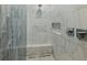 Elegant walk-in shower with marble tile, a built-in bench, and modern fixtures at 2153 Starfire Drive Ne Dr, Atlanta, GA 30345