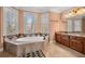 A luxurious bathroom showcases a large soaking tub with marble accents, and double vanity at 3017 Canton Pines, Marietta, GA 30068
