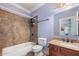 Well-lit bathroom featuring a tub-shower combo with tile surround, granite countertop, and modern fixtures at 3017 Canton Pines, Marietta, GA 30068