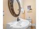 Half bath featuring a unique round mirror and decorative accents at 3017 Canton Pines, Marietta, GA 30068