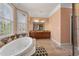 This spacious bathroom boasts a soaking tub, granite countertops, and access to natural lighting at 3017 Canton Pines, Marietta, GA 30068
