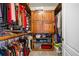 Organized walk-in closet with custom shelving, hanging rods, and storage for clothes and accessories at 3017 Canton Pines, Marietta, GA 30068