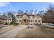 Impressive stone home featuring a fountain, manicured landscaping, and a private driveway at 3017 Canton Pines, Marietta, GA 30068