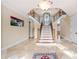 Spacious foyer with a winding staircase, elegant lighting, and travertine flooring at 3017 Canton Pines, Marietta, GA 30068
