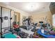 Home gym with a variety of exercise equipment, mirrors, and ample space for workouts at 3017 Canton Pines, Marietta, GA 30068