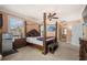 Spacious main bedroom suite features a four-poster bed, ceiling fan, and adjoining bath access at 3017 Canton Pines, Marietta, GA 30068